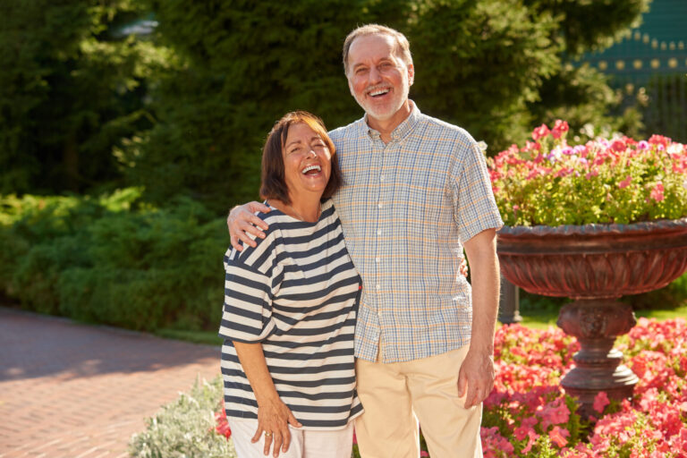 Grandparents Portrait In The Garden. Senior Dental Care page with two smiling people