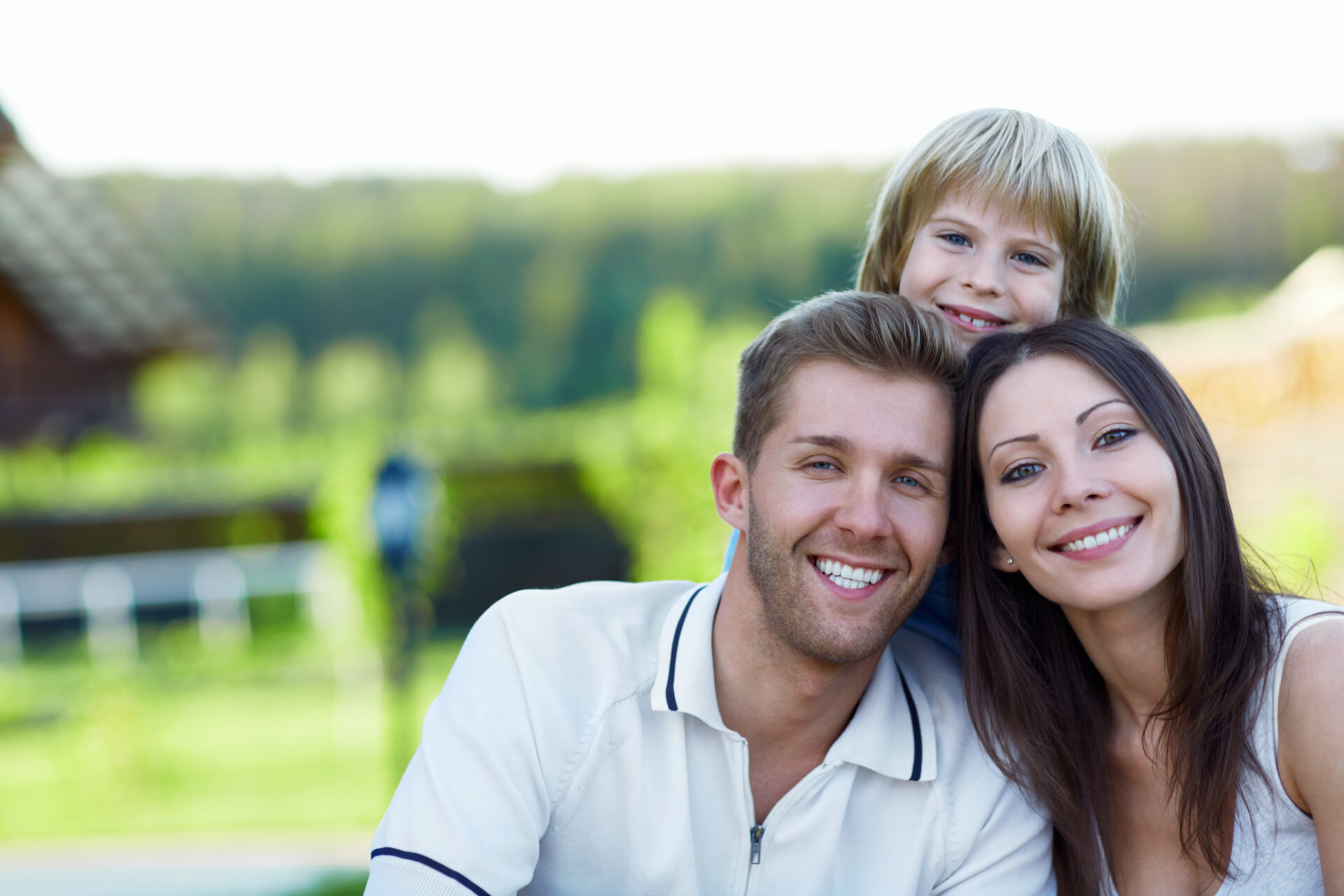 Smiling Family Smiling family with child outdoors